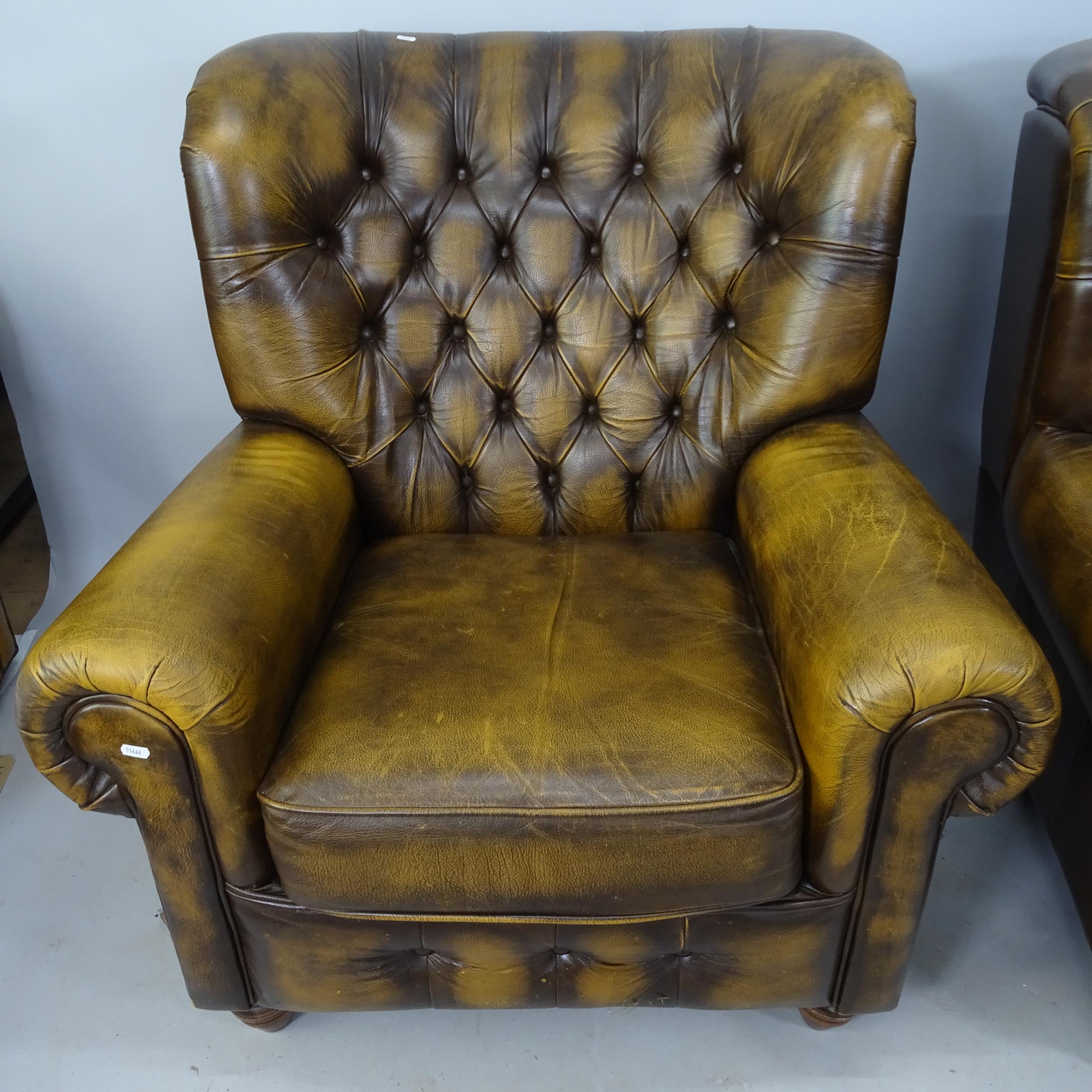 A pair of Thomas Lloyd studded brown leather upholstered wing armchairs ...