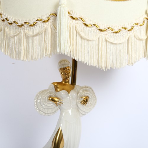 412 - A table lamp supported by a ceramic gilded figure, with ornate shade, height 60cm overall