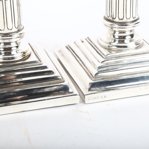 1055 - A pair of Colonial Corinthian column silver candlesticks, height 14.5cm, marked Silver S.B