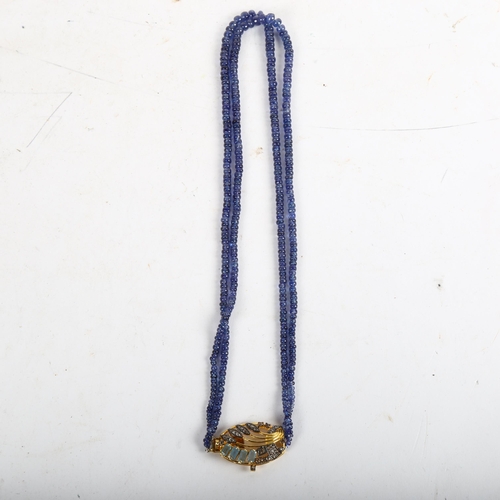 1064 - A modern double-strand graduated sapphire bead necklace, on silver-gilt clasp, set with aquamarine a... 