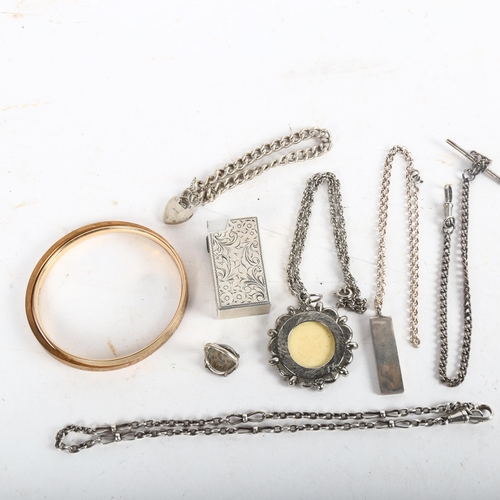 1072 - A group of silver jewellery, including a pendant necklace, an Albert pendant and chains, and an engr... 