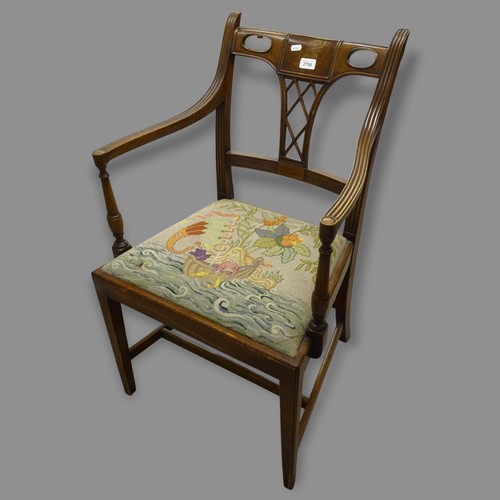 2706 - An early 20th century mahogany open arm chair, with carved and fluted decoration, on square tapered ... 