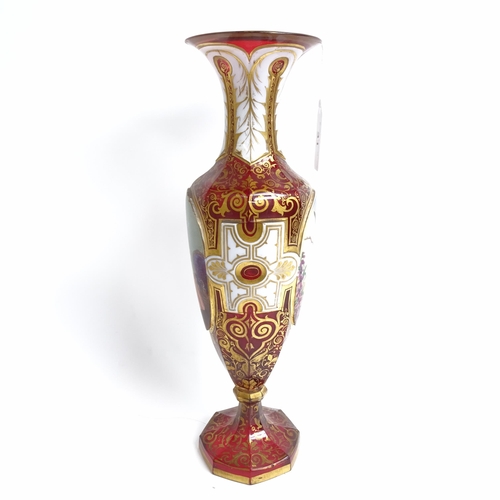 31 - A 19th century Bohemian cranberry glass portrait vase, allover gilded and white enamelled decoration... 