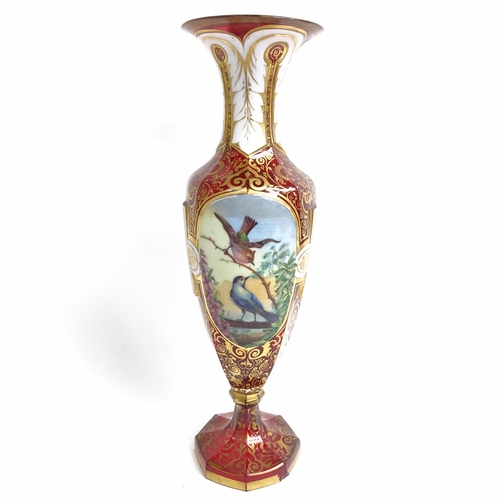 31 - A 19th century Bohemian cranberry glass portrait vase, allover gilded and white enamelled decoration... 