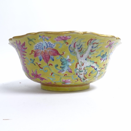 204 - A Chinese famille rose bowl, with flared lobed rim, on turned foot, with mystical beast design, diam... 