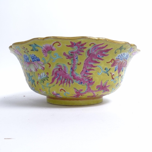 204 - A Chinese famille rose bowl, with flared lobed rim, on turned foot, with mystical beast design, diam... 