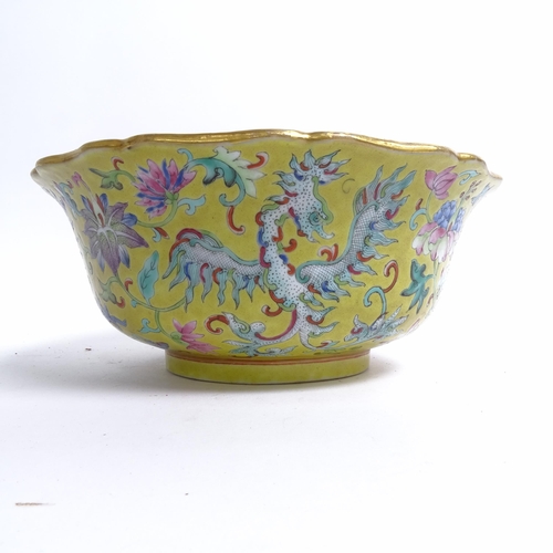 204 - A Chinese famille rose bowl, with flared lobed rim, on turned foot, with mystical beast design, diam... 