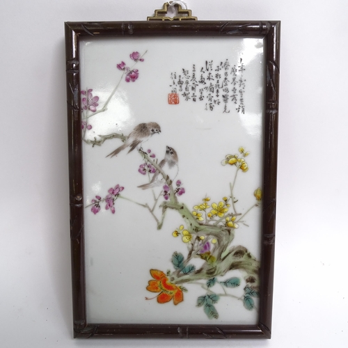 214 - A pair of Chinese porcelain plaques, with enamelled decoration of blossom and exotic birds, in faux ... 