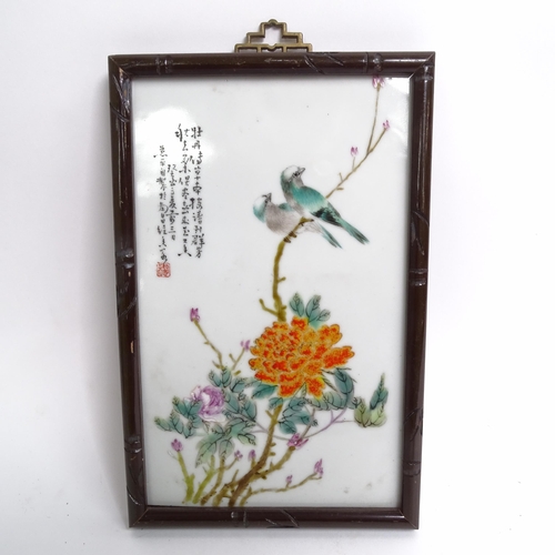 214 - A pair of Chinese porcelain plaques, with enamelled decoration of blossom and exotic birds, in faux ... 