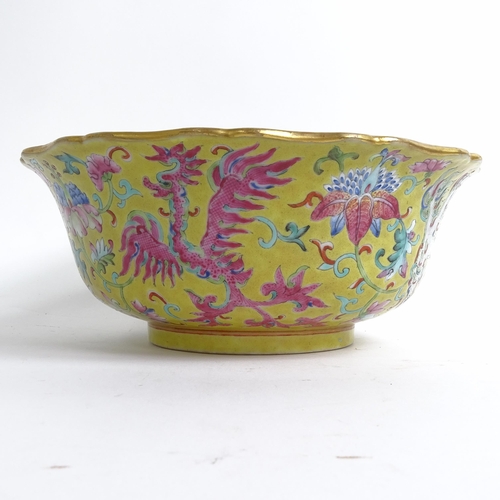 204 - A Chinese famille rose bowl, with flared lobed rim, on turned foot, with mystical beast design, diam... 