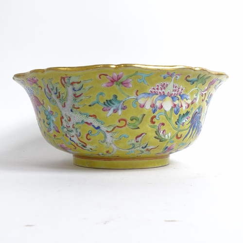 204 - A Chinese famille rose bowl, with flared lobed rim, on turned foot, with mystical beast design, diam... 