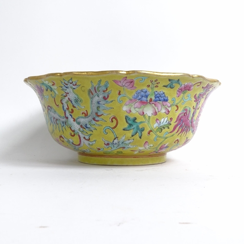 204 - A Chinese famille rose bowl, with flared lobed rim, on turned foot, with mystical beast design, diam... 