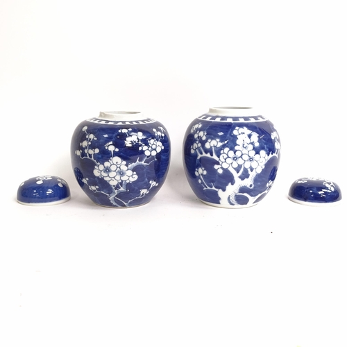 209 - 3 Chinese blue and white ginger jar and covers, all prunus decorated, on stands, 1 lacking its lid, ... 