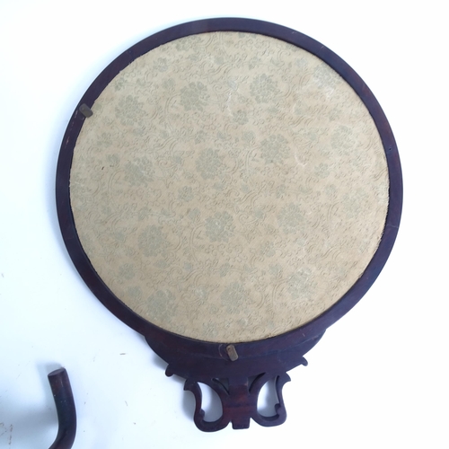 218 - A Chinese padauk wood framed revolving table screen, the circular panel having an inset silk work st... 