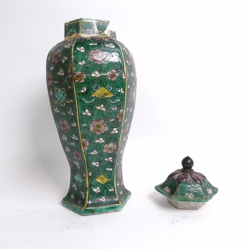 230 - A Chinese famille verte green ground hexagonal baluster vase and cover, Kangxi Period with prunus an... 