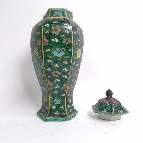 230 - A Chinese famille verte green ground hexagonal baluster vase and cover, Kangxi Period with prunus an... 