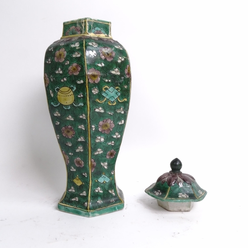 230 - A Chinese famille verte green ground hexagonal baluster vase and cover, Kangxi Period with prunus an... 