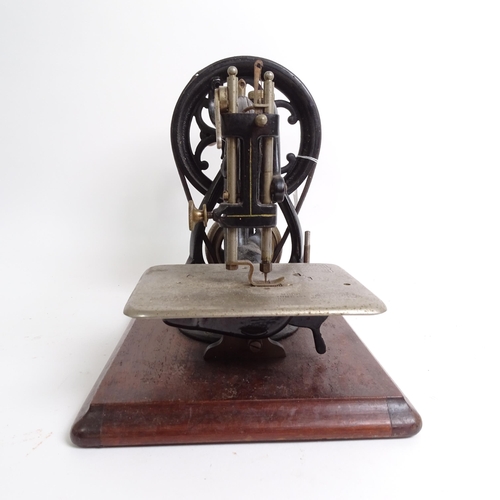 455 - Antique Willcox & Gibbs sewing machine with gilded decoration, on plinth, with original tin for acce... 