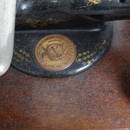 455 - Antique Willcox & Gibbs sewing machine with gilded decoration, on plinth, with original tin for acce... 