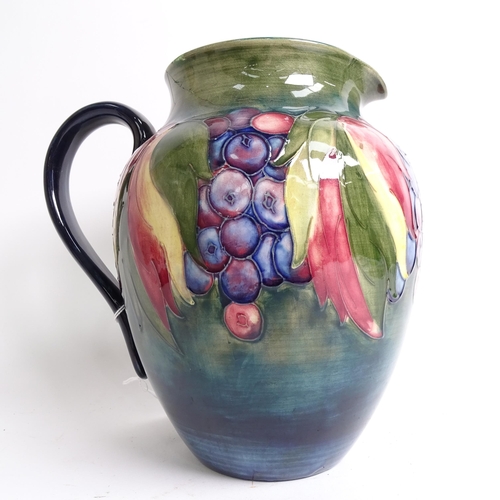 718 - A Moorcroft jug with tube-lined fruit decoration (A/F), signed William Moorcroft, height 20cm