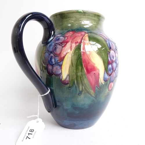 718 - A Moorcroft jug with tube-lined fruit decoration (A/F), signed William Moorcroft, height 20cm