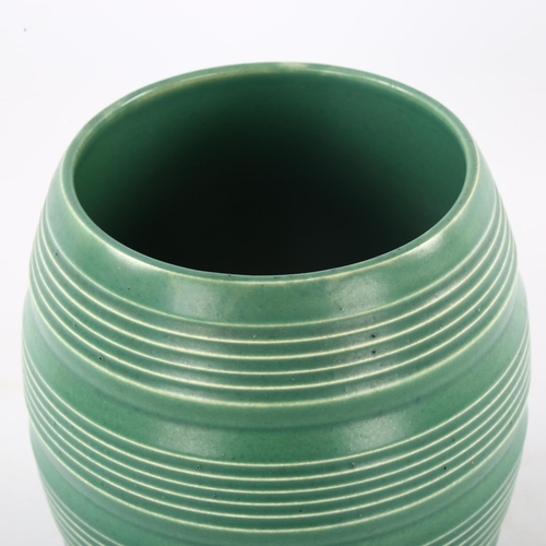 86 - KEITH MURRAY for Wedgwood, a 1930s' ribbed vase in Matt Green, makers marks to base, height 17.5cm