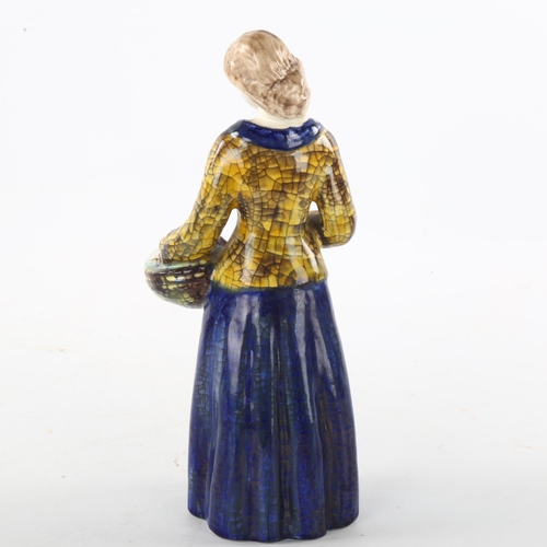 98 - MARIANNE STARCK for Michael Andersen, a Danish pottery figurine of a woman holding a basket of fruit... 