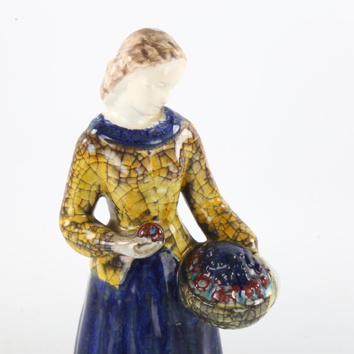 98 - MARIANNE STARCK for Michael Andersen, a Danish pottery figurine of a woman holding a basket of fruit... 