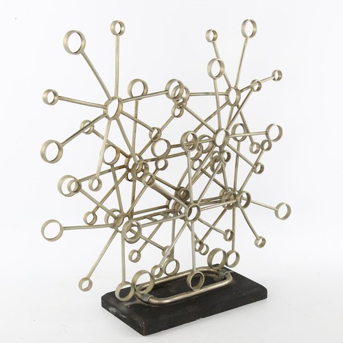 129 - A 1960s' brutalist snowflake sculpture of sketetal form on an ebonised wood base, inscription to und... 