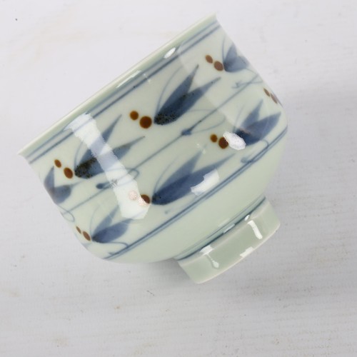 162 - DEREK CLARKSON, a studio pottery porcelain tea bowl, with celadon, cobalt and iron glaze, maker stam... 