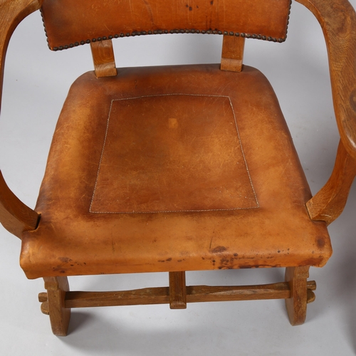 126 - A pair of craftsman made Art and Craft oak armchairs, with leather upholstery, height 81cm