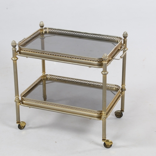 131 - A small 1950s/60's drinks trolley / side table, with smoked glass shelves, 50 x 30cm, height 41cm.