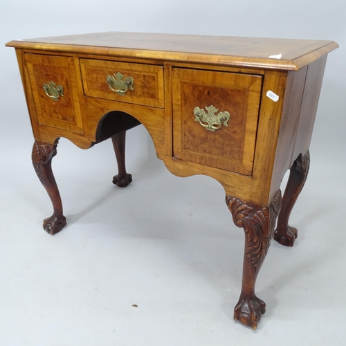 2009 - An Antique crossbanded walnut lowboy, with 3 fitted drawers, on mahogany cabriole legs with claw and... 