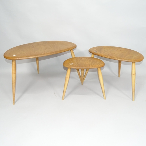 2006 - A mid-century Ercol elm nest of three pebble occasional tables, largest 66cm x 41cm x 45cm