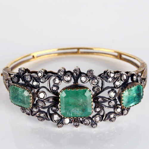 1109 - A fine Victorian emerald and diamond hinged bangle, unmarked gold and silver-topped openwork setting... 