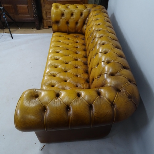 2021 - A buttoned brown leather-upholstered Chesterfield sofa, 200 x 80 x 85cm