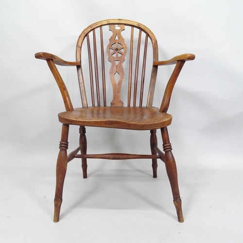 2025 - An early 19th Century elm seated wheel-back elbow chair