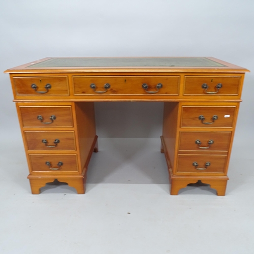 2040 - A modern yew wood twin-pedestal writing desk, with tooled and embossed leather skiver and 9 fitted d... 