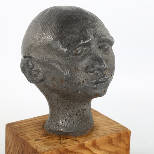 205 - An unusual mid-20th century solid lead head sculpture, on woodblock plinth, unsigned, height 22cm