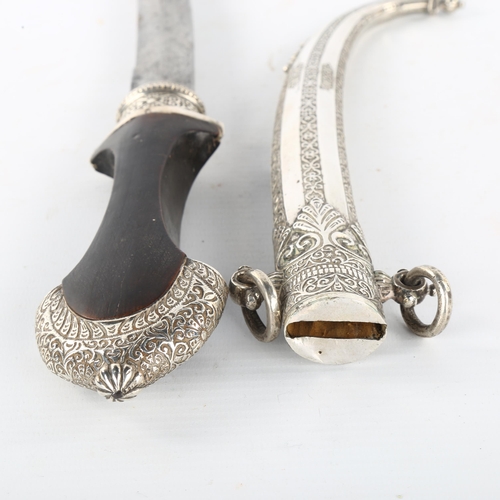 207 - A Moroccan dagger, probably mid-20th century, unmarked white metal mounts and wood handle, overall l... 