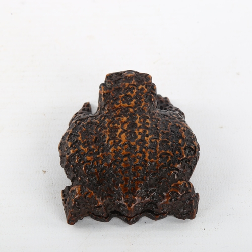 211 - An unusual Victorian treen snuffbox in the form of a toad, with sliding lid under his belly, length ... 