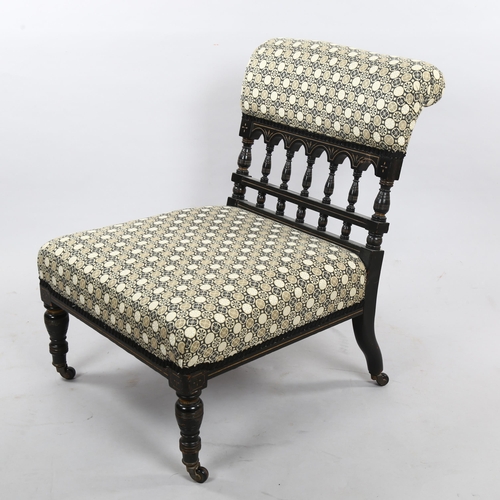 217 - A Victorian Aesthetic Movement nursing chair, ebonised spindled frame recently re-upholstered in Jap... 