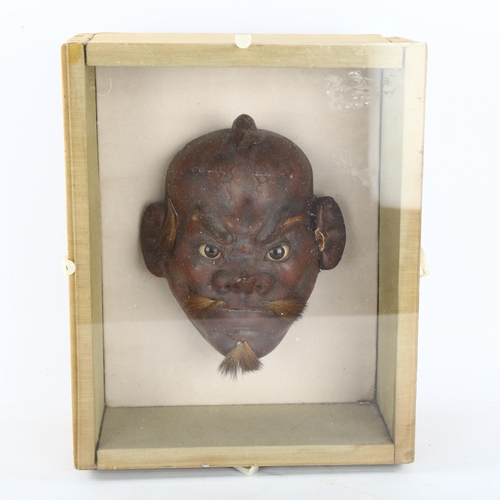 241 - A Chinese carved and lacquered wood mask sculpture, height 16cm, mounted in glazed box frame