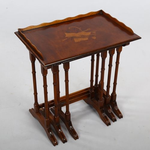 266 - A nest of 3 walnut occasional tables, with inlaid musical marquetry designs, largest width 56cm