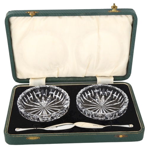 297 - A pair of glass butter dishes, with silver butter knives, hallmarks Sheffield 1937, dish diameter 10... 