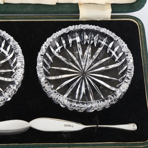 297 - A pair of glass butter dishes, with silver butter knives, hallmarks Sheffield 1937, dish diameter 10... 