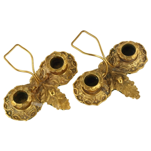 312 - A pair of Regency solid cast gilt-bronze twin-sconce candle stands, with relief moulded acorn design... 