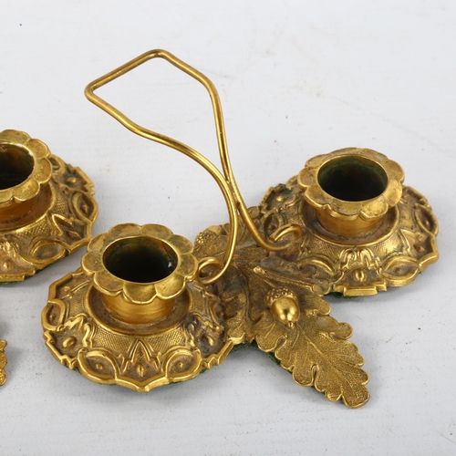 312 - A pair of Regency solid cast gilt-bronze twin-sconce candle stands, with relief moulded acorn design... 