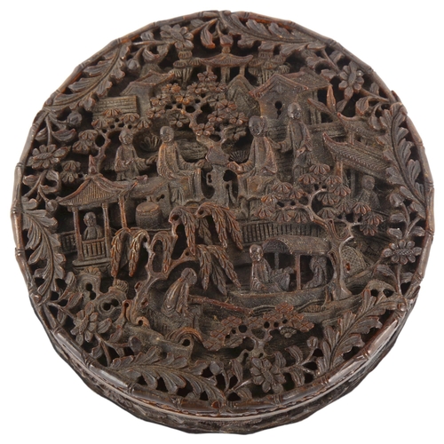 316 - A large Chinese tortoiseshell circular box, allover high relief carved landscape scenes, diameter 9.... 