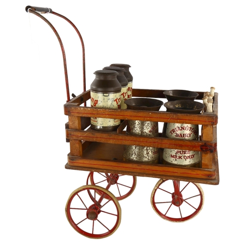 357 - A rare Tri-ang toy milk cart, stained wood and metal, containing original tinplate milk churns and p... 